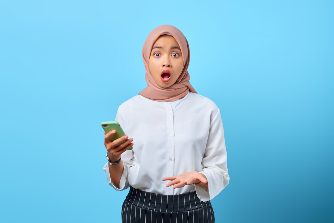 woman looking at smartphone with doubt expression