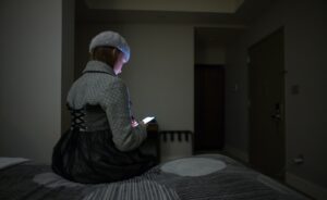 single mother using smartphone at night