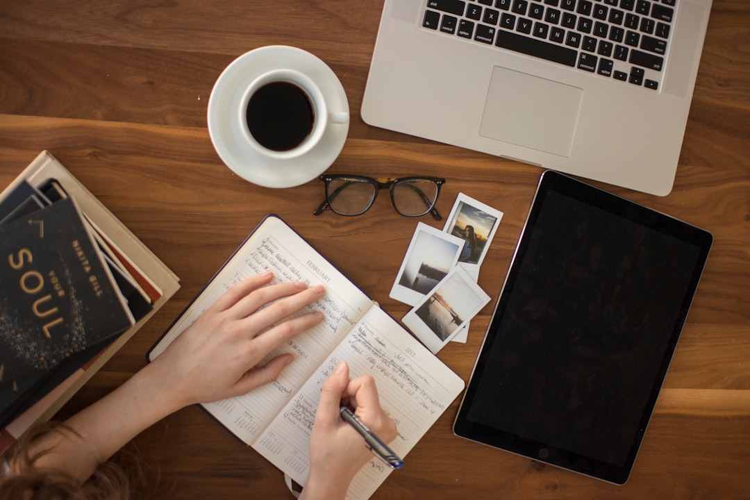woman writing goals in notebook
