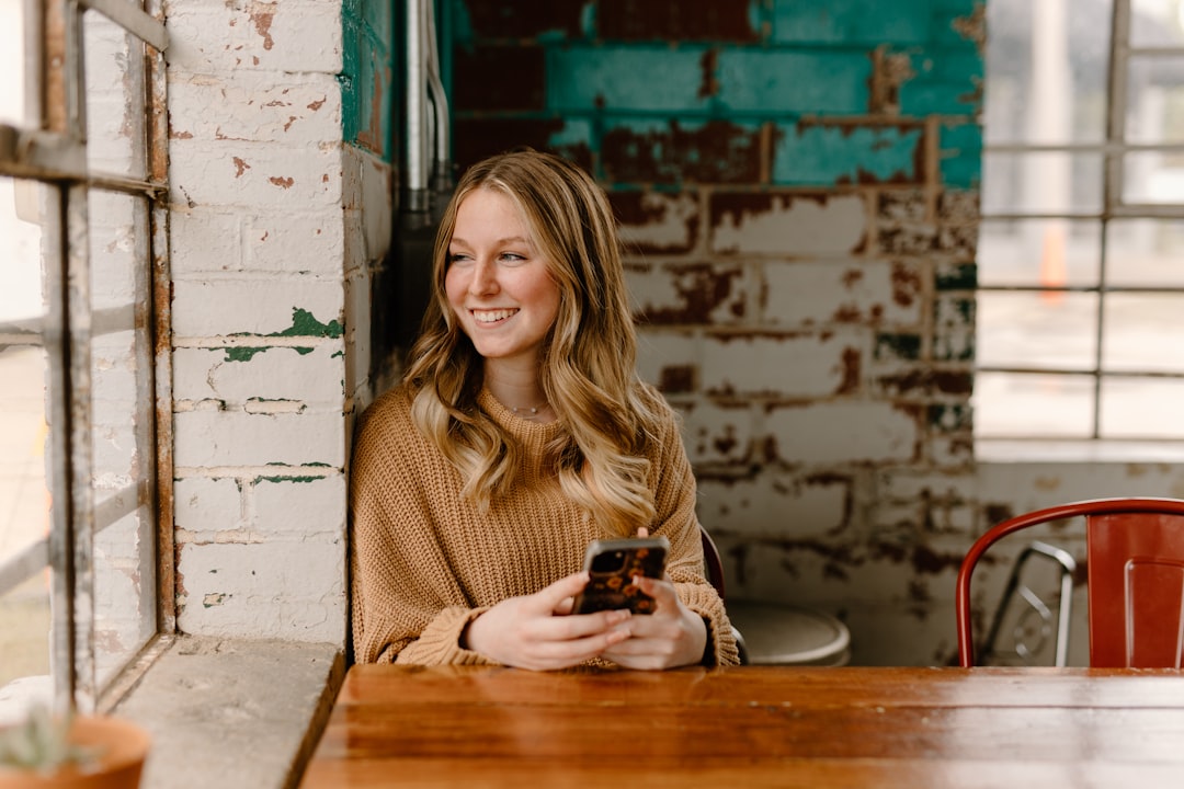 smiling woman texting on smartphone