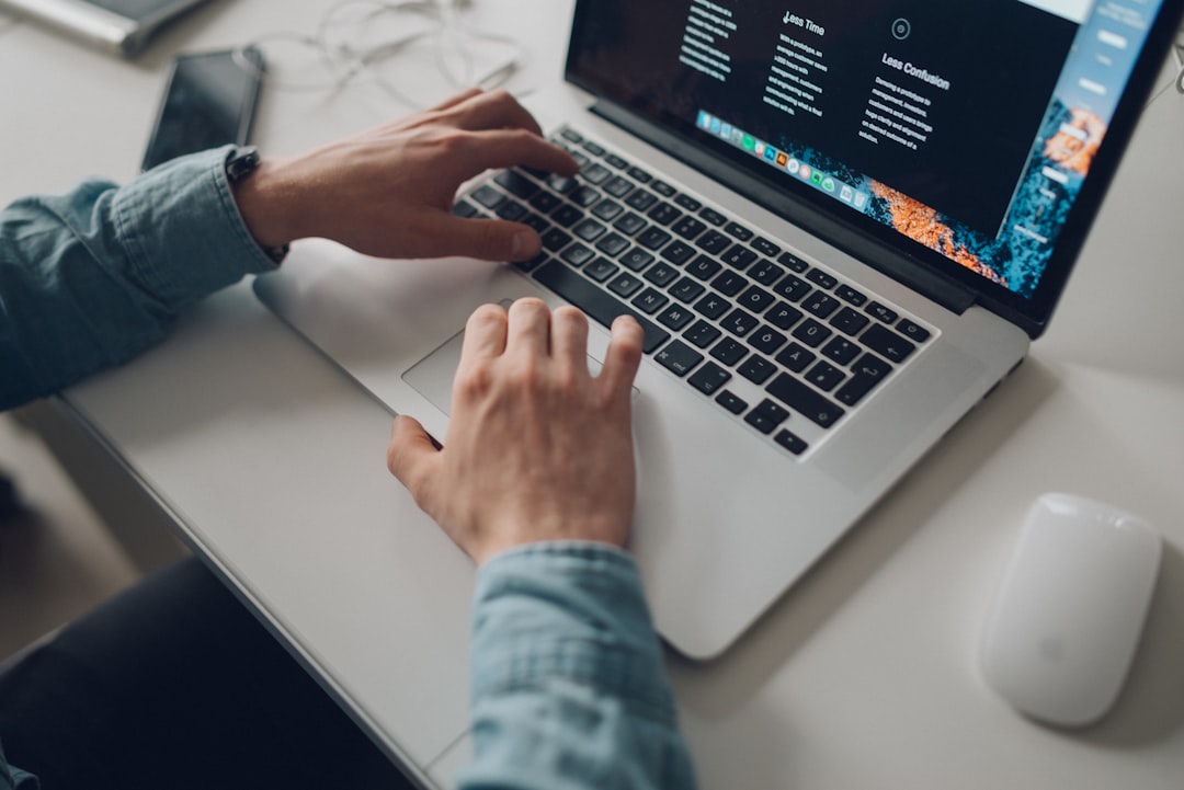 man writing profile on laptop