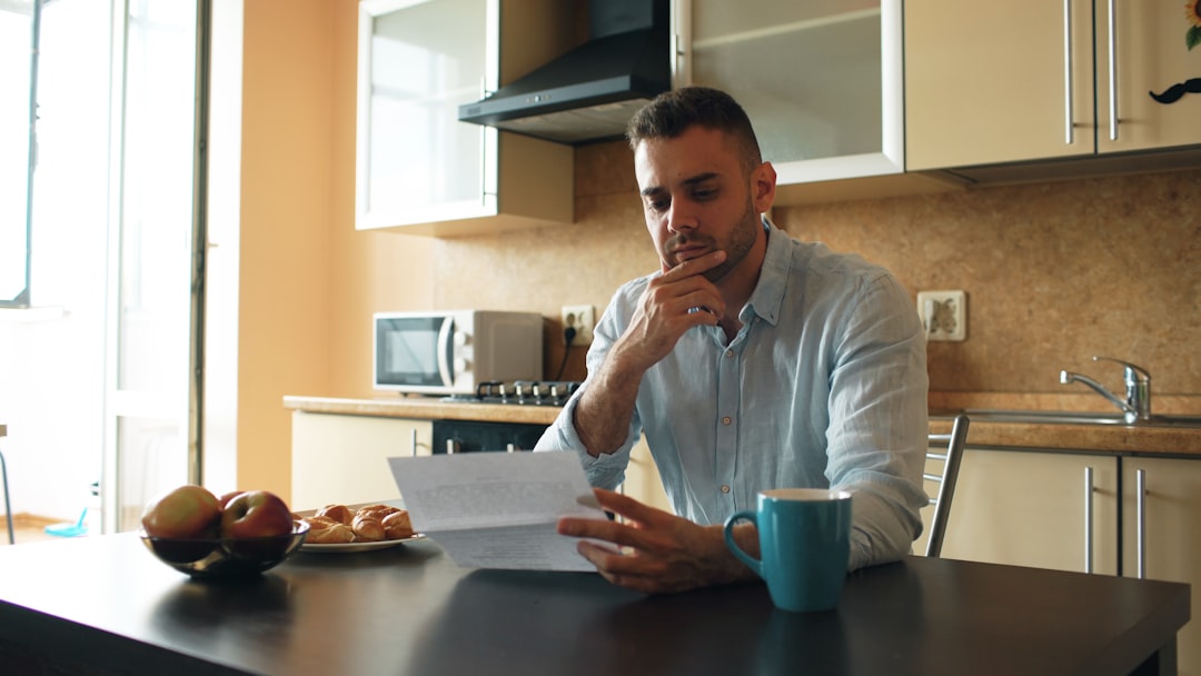 middle aged man thinking with coffee at home