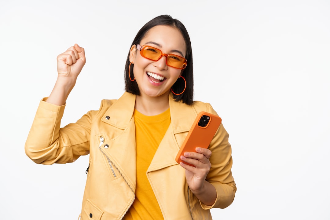 woman feeling relieved holding phone