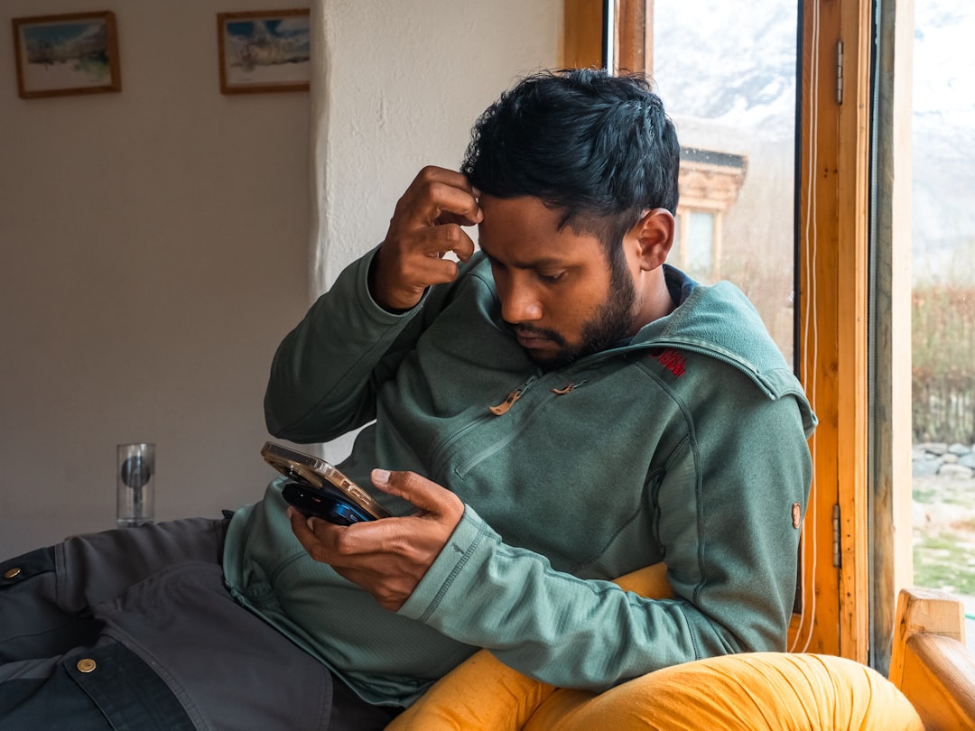 frustrated man looking at smartphone