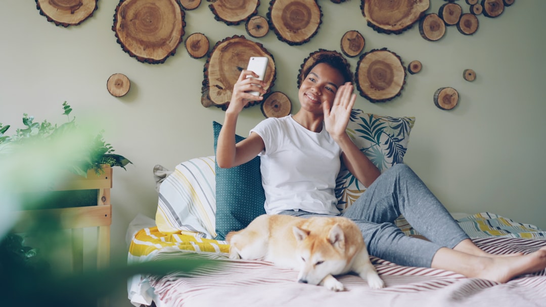woman video call smartphone home