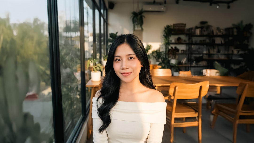 confident woman smiling in cafe window light