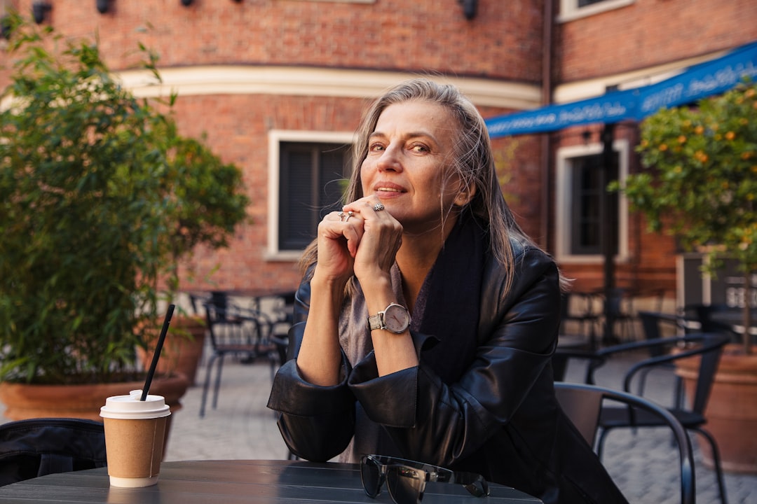 middle aged woman hopeful smiling cafe