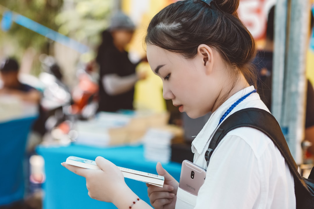 japanese woman looking at smartphone data chart