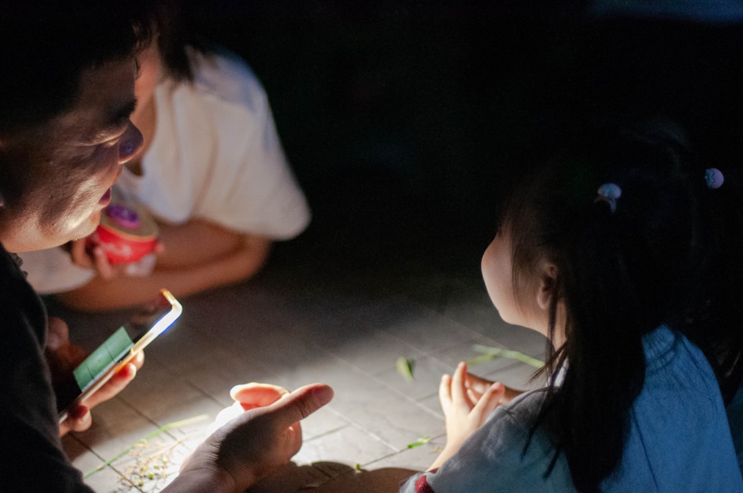 single mother looking at smartphone at night