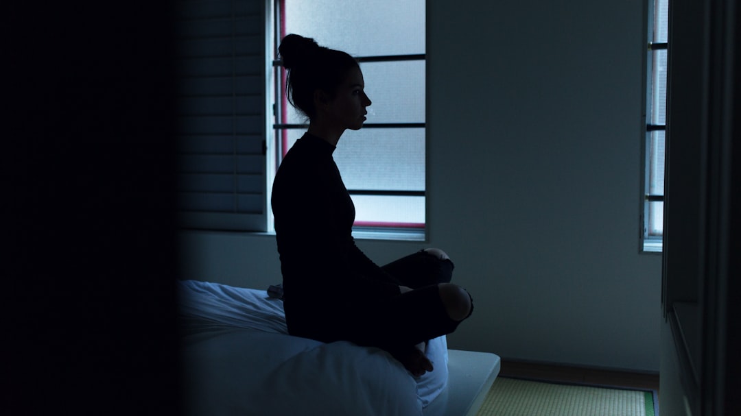 woman alone thinking window night