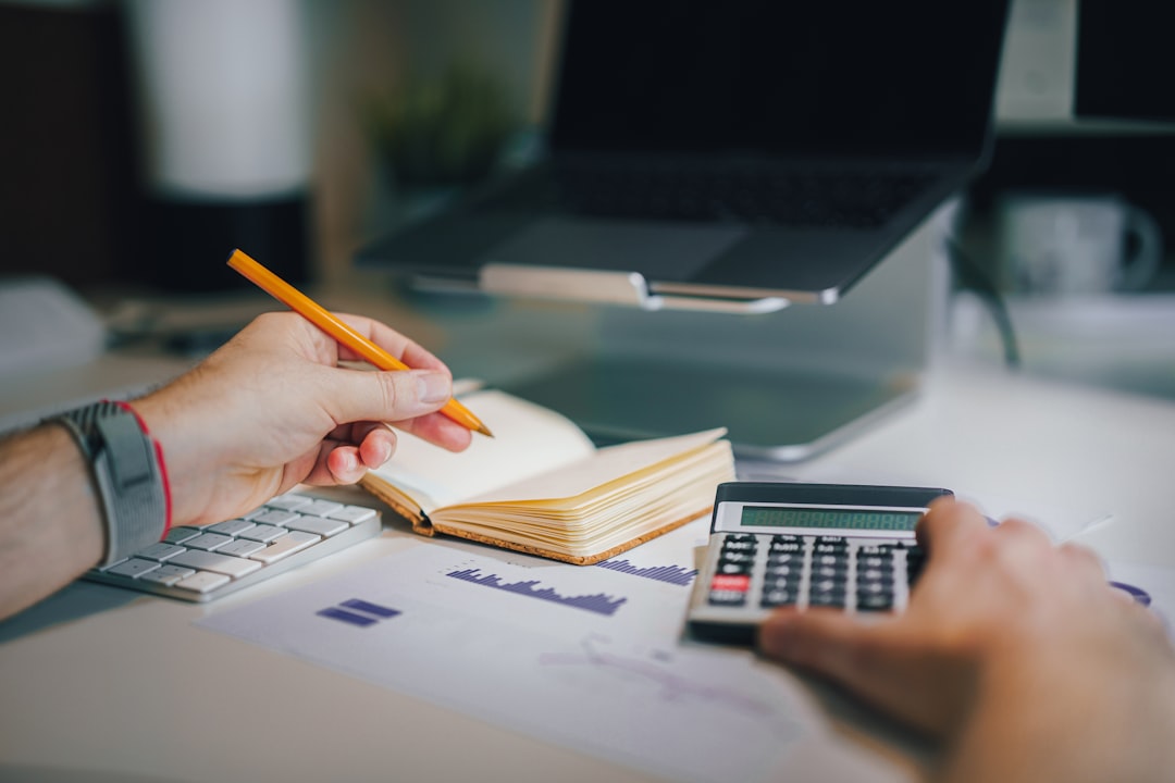 person managing budget with calculator