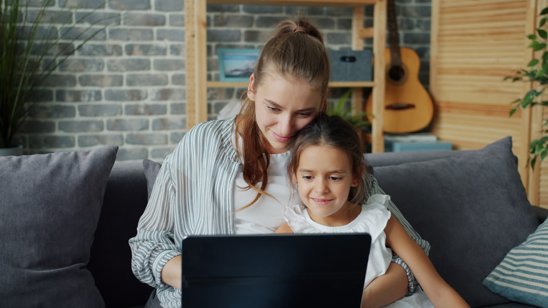 single mother with child using laptop at home