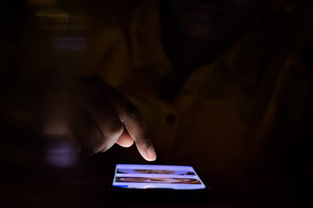 man looking at smartphone dating app at night