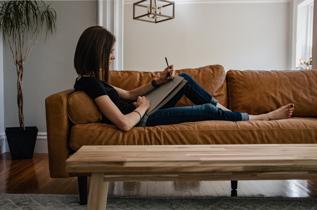 woman writing in journal at home