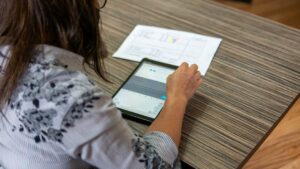 japanese woman looking at smartphone data chart