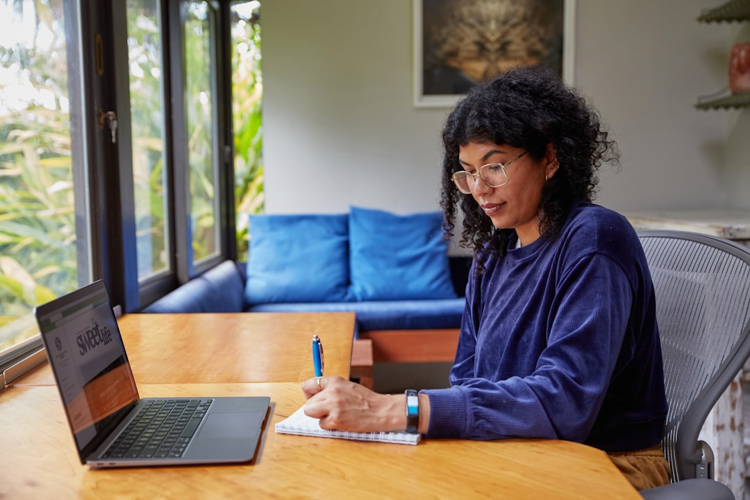 woman reviewing checklist with laptop at home