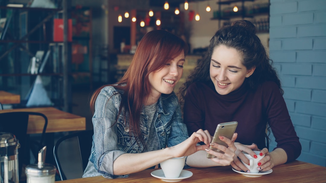 happy woman using smartphone cafe