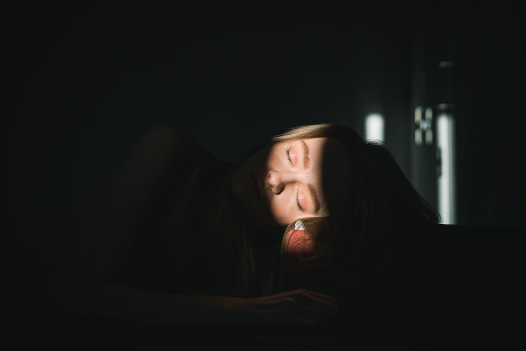 tired woman looking at smartphone at night
