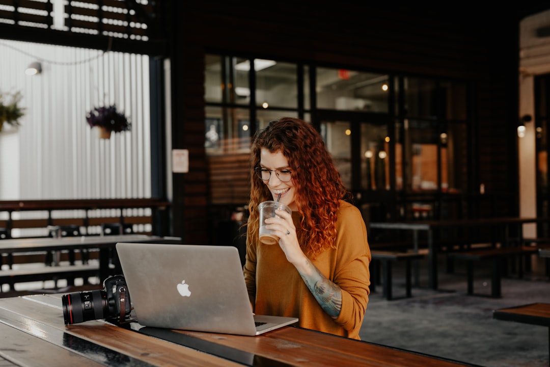 woman thinking with laptop cafe