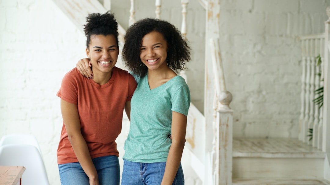 single mother and daughter smiling together at home