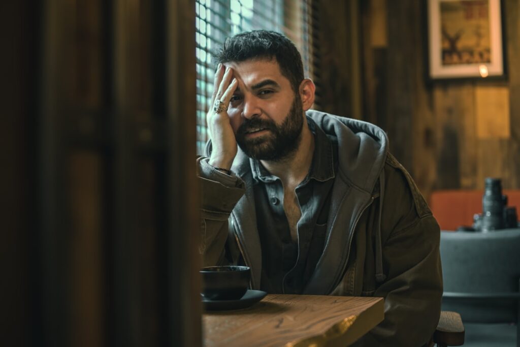 woman thinking alone at cafe with coffee