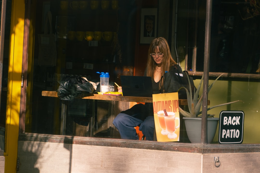 woman thinking laptop cafe decision