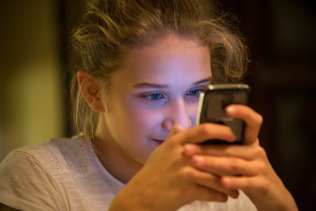 young woman worried smartphone night
