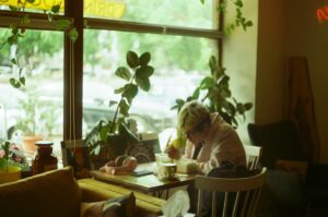woman using smartphone cozy cafe