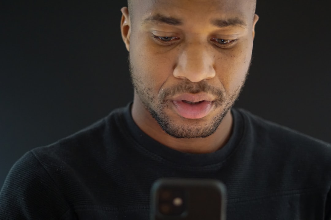 man tired using smartphone at night