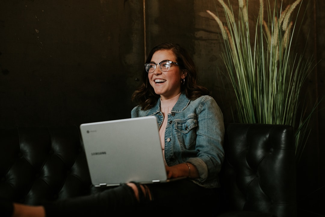happy woman reading good news on laptop