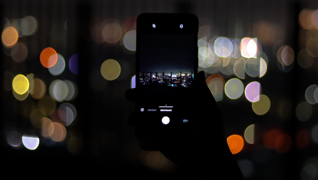 person looking at smartphone dating app at night
