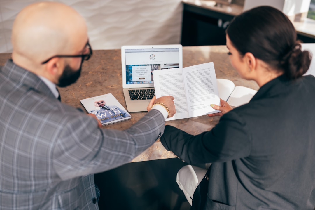 two business people comparing options meeting