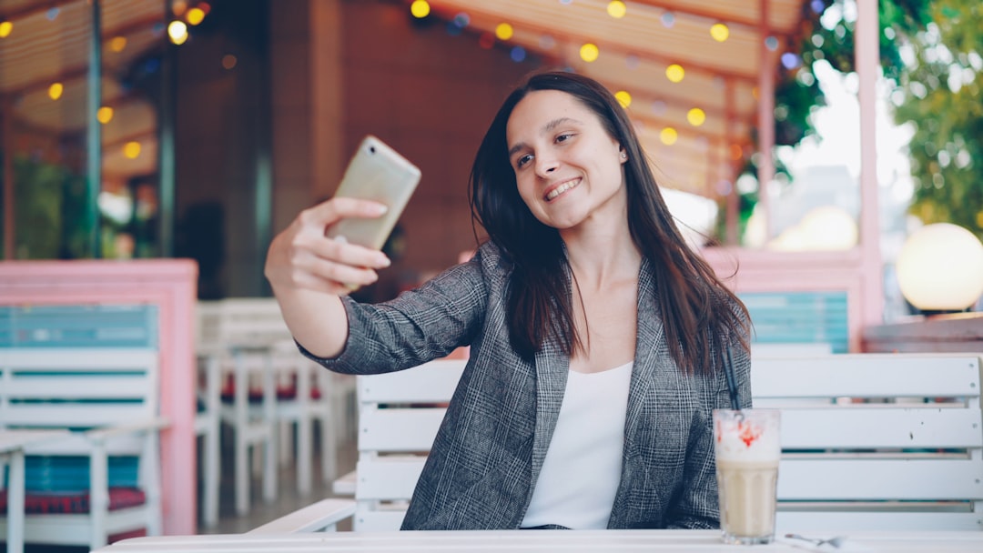 woman video call smartphone cafe