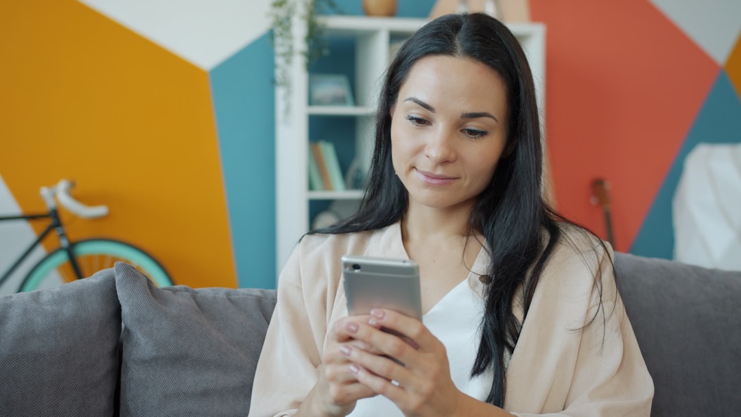 woman using smartphone dating app in modern apartment