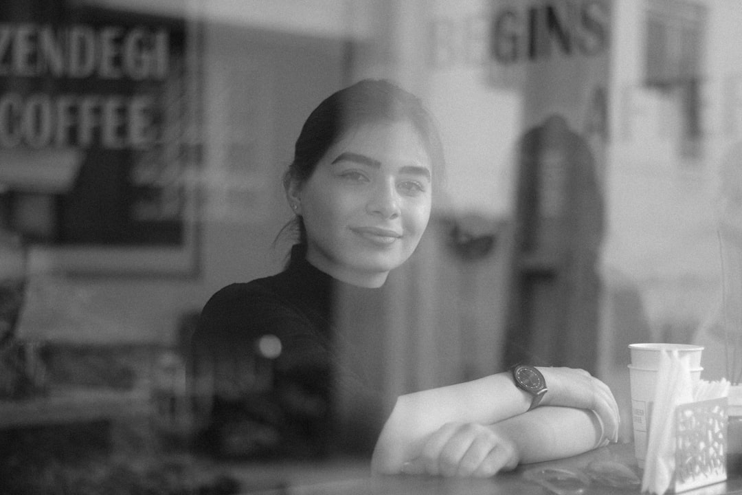 confident woman smiling cafe window