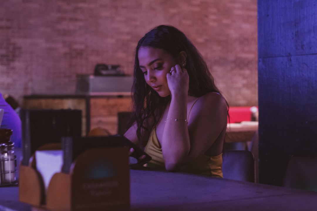 woman looking worried at phone night
