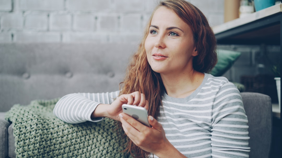 woman using smartphone dating app cozy