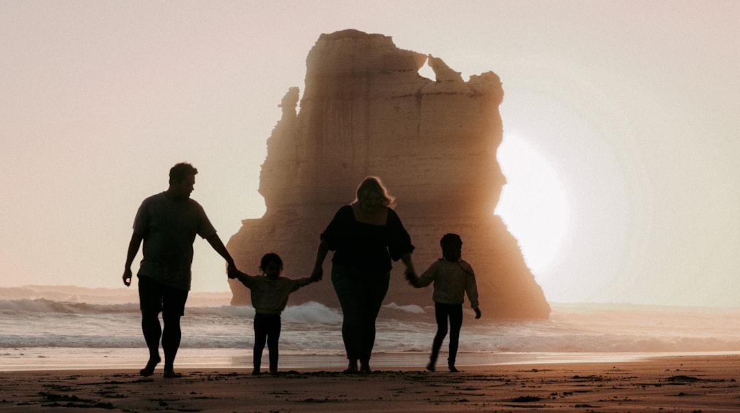 family holding hands walking outdoors