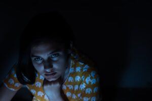 young woman worried smartphone night
