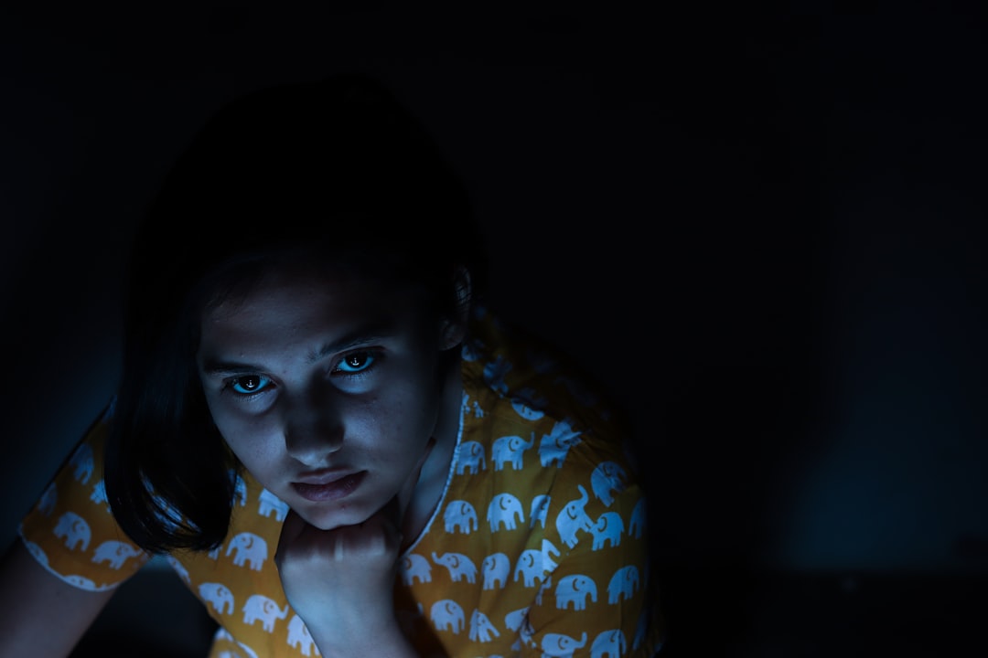 young woman worried smartphone night