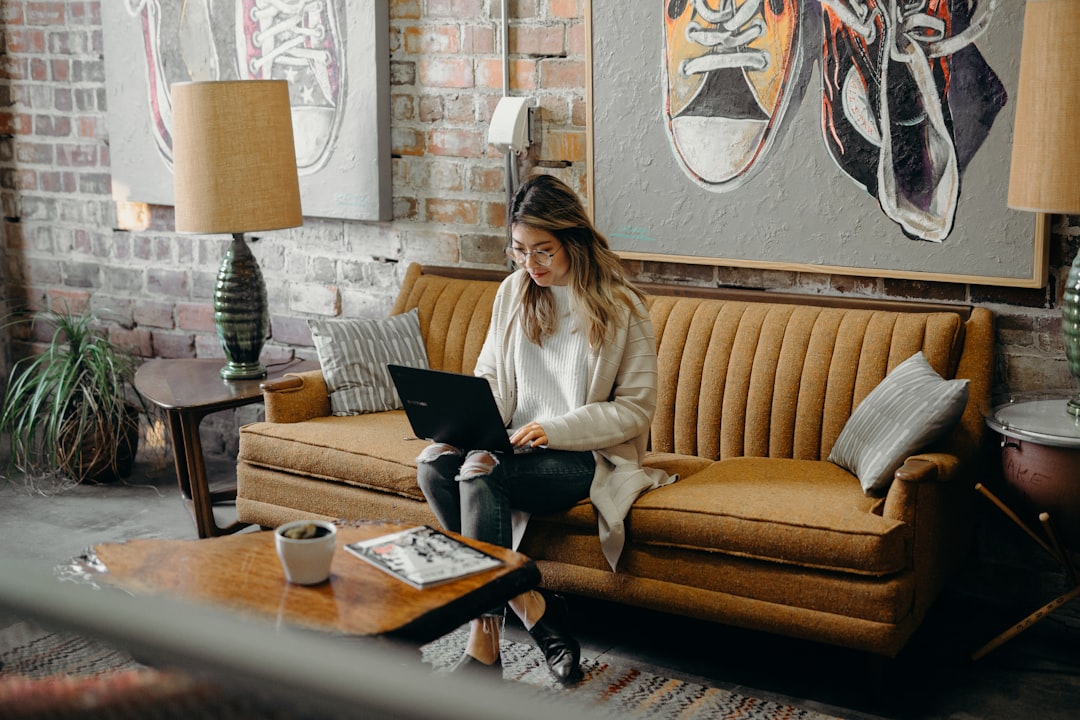woman reviewing financial documents laptop cafe