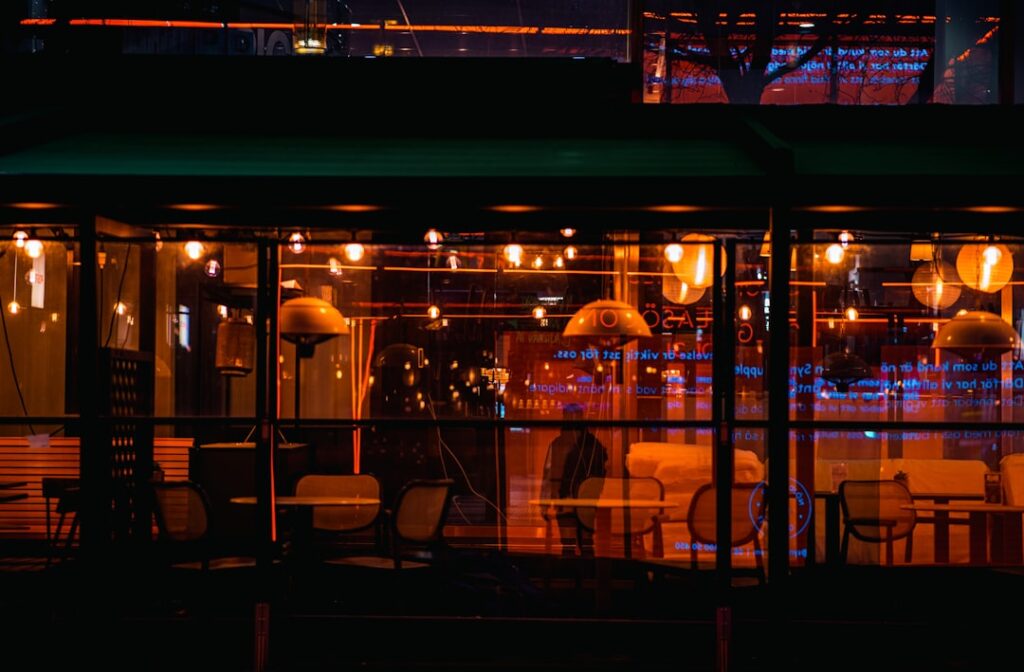 woman using smartphone at night cafe