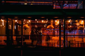 woman using smartphone at night cafe