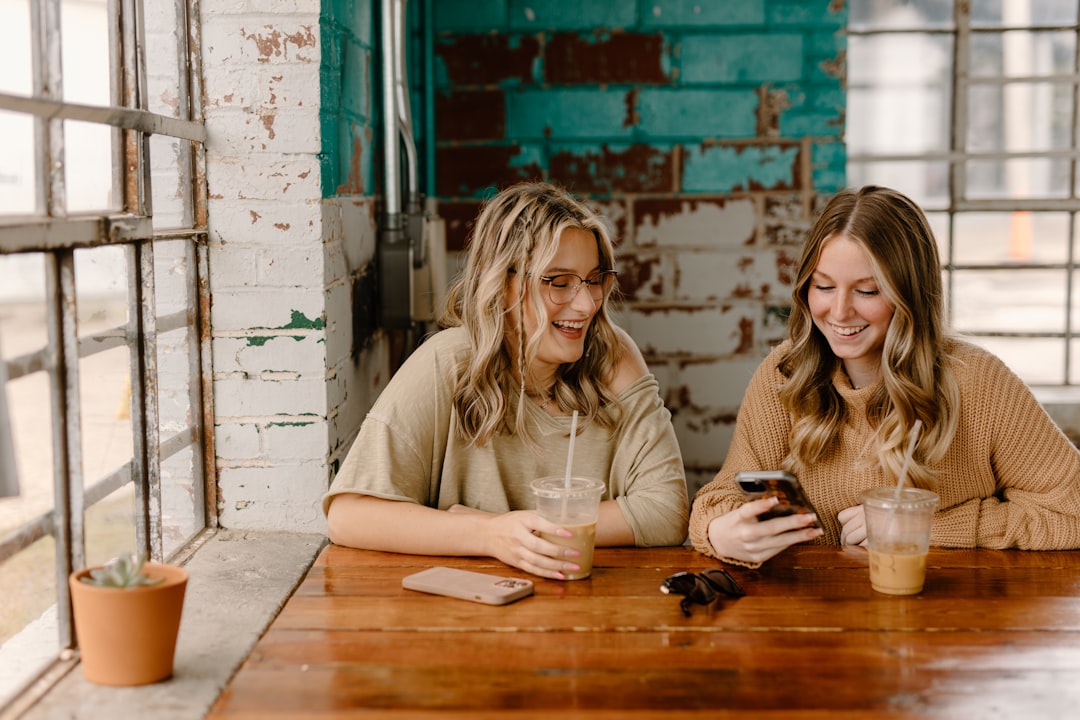 couple texting smiling coffee shop