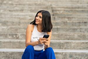 woman typing message smartphone smiling