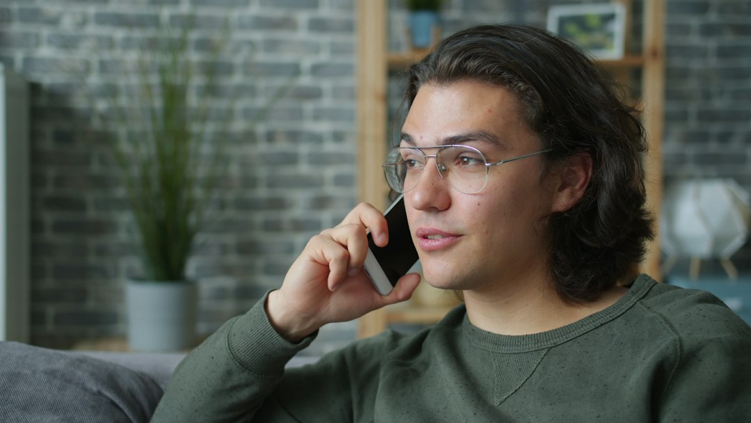 person looking thoughtful at phone indoor