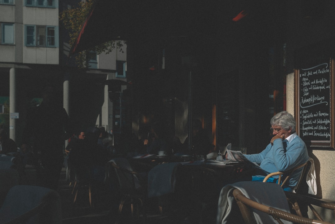 calm thoughtful man reading in cafe