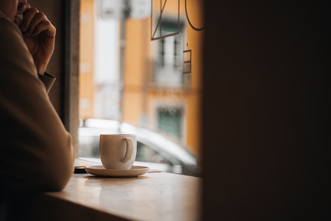 woman thinking coffee cafe window