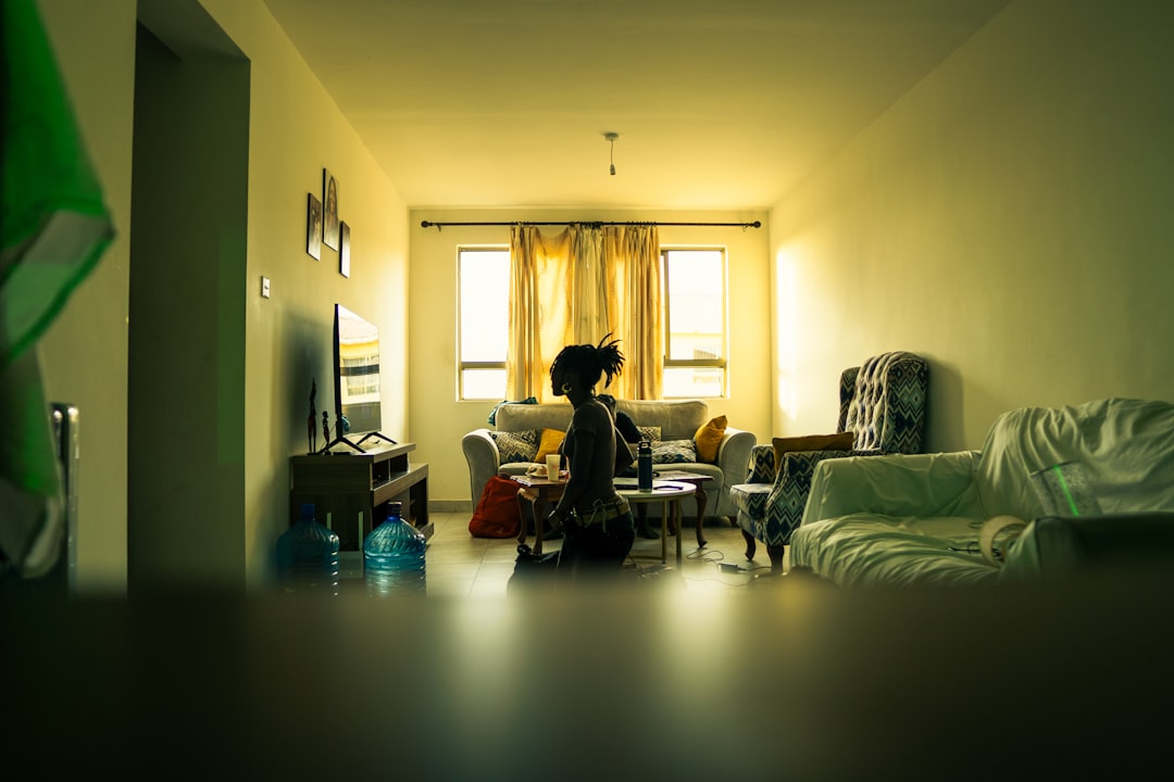 woman using smartphone at home evening warm light
