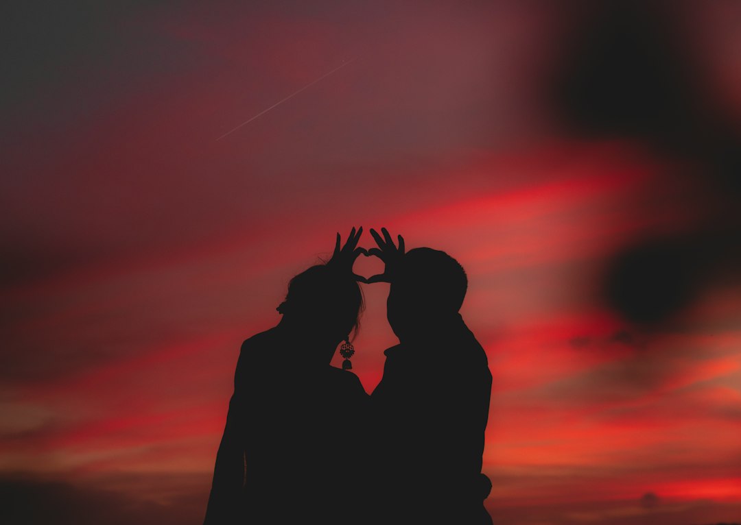 man and woman silhouette thinking sunset